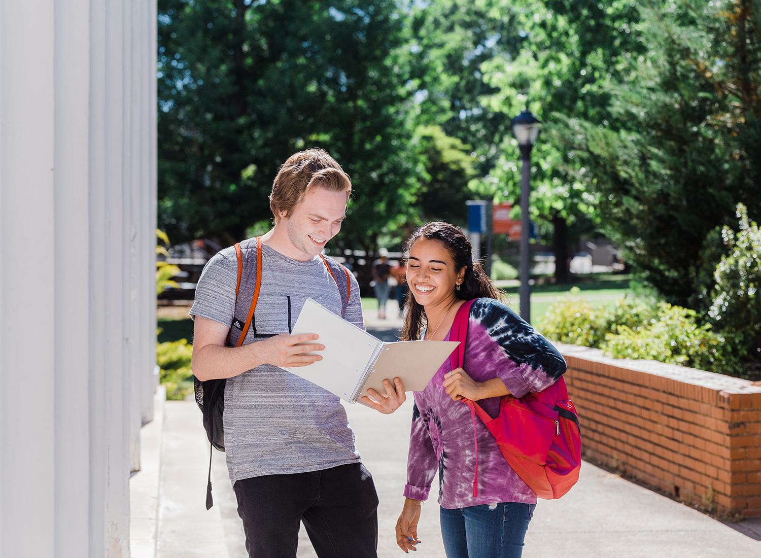 Two students walking on campus